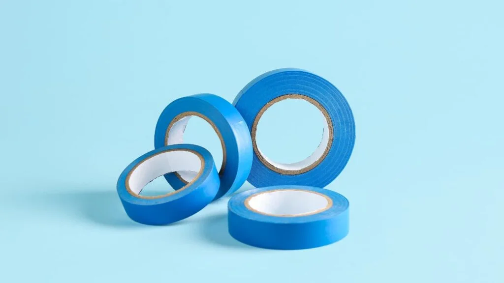 Painters tape on a roll with blue background